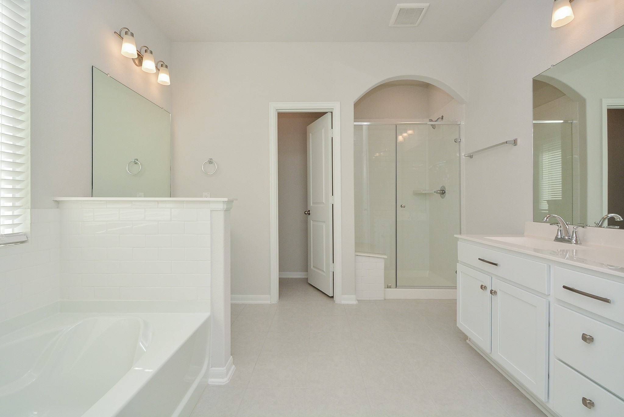 8634 Herring Lane Cypress, TX 77433 - Photo 32 of 50 a spacious bathroom with a mirror a shower and vanity