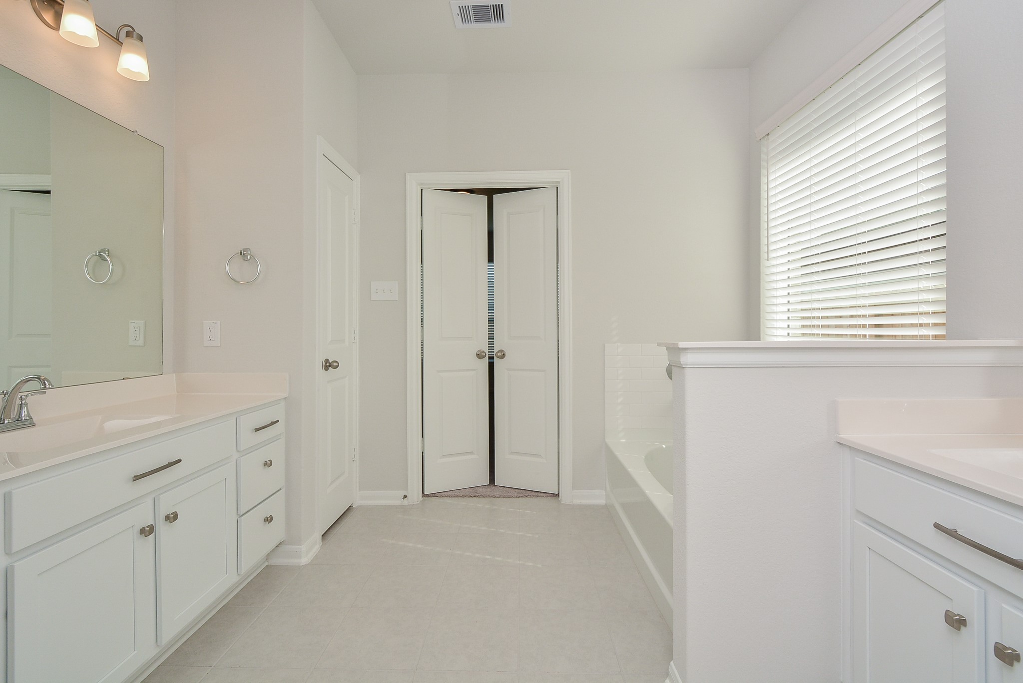 8634 Herring Lane Cypress, TX 77433 - Photo 33 of 50 a spacious bathroom with double vanity and a mirror