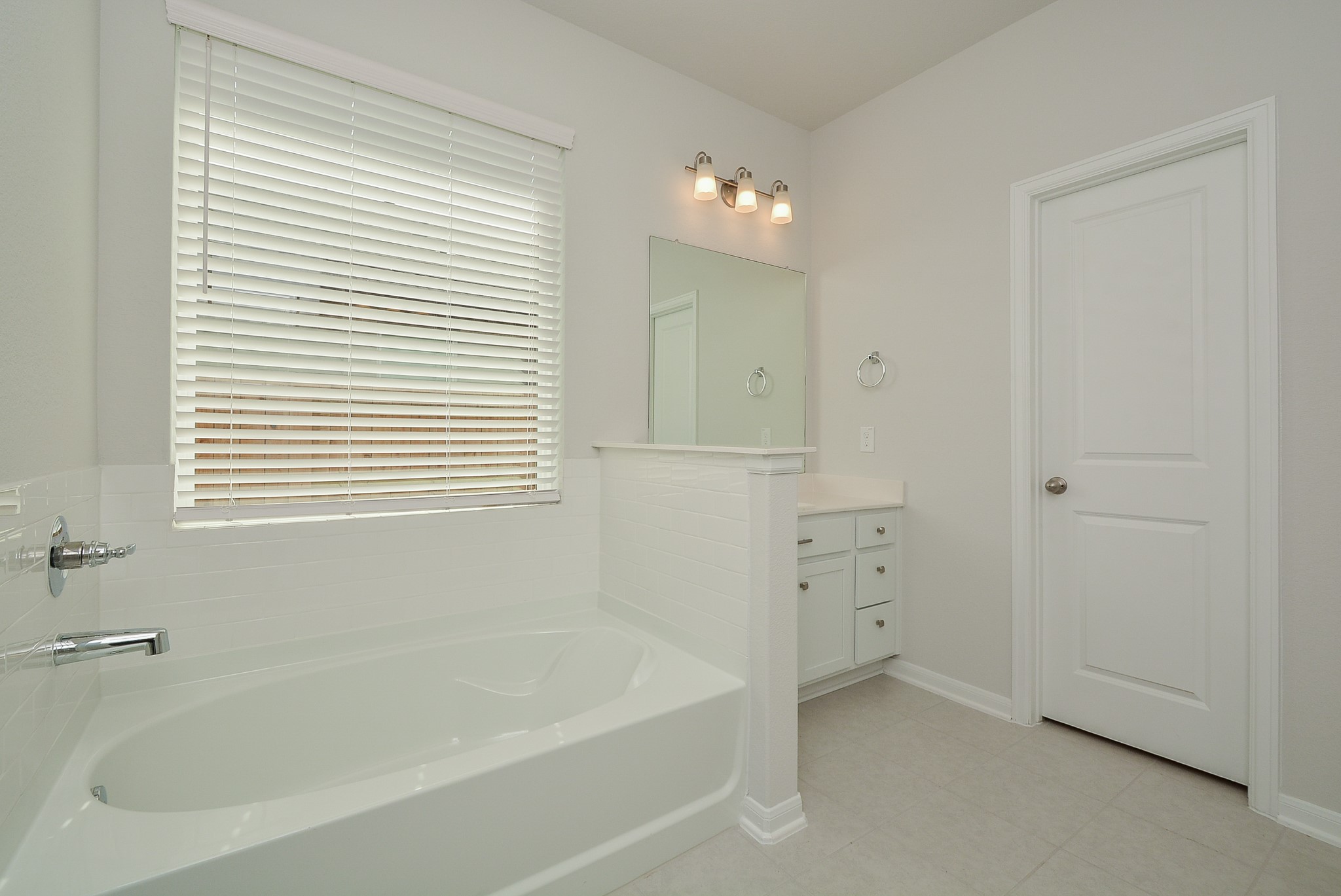 8634 Herring Lane Cypress, TX 77433 - Photo 36 of 50 a bathroom with a bathtub and a shower