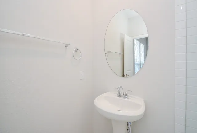 a white toilet sitting next to a bathroom sink
