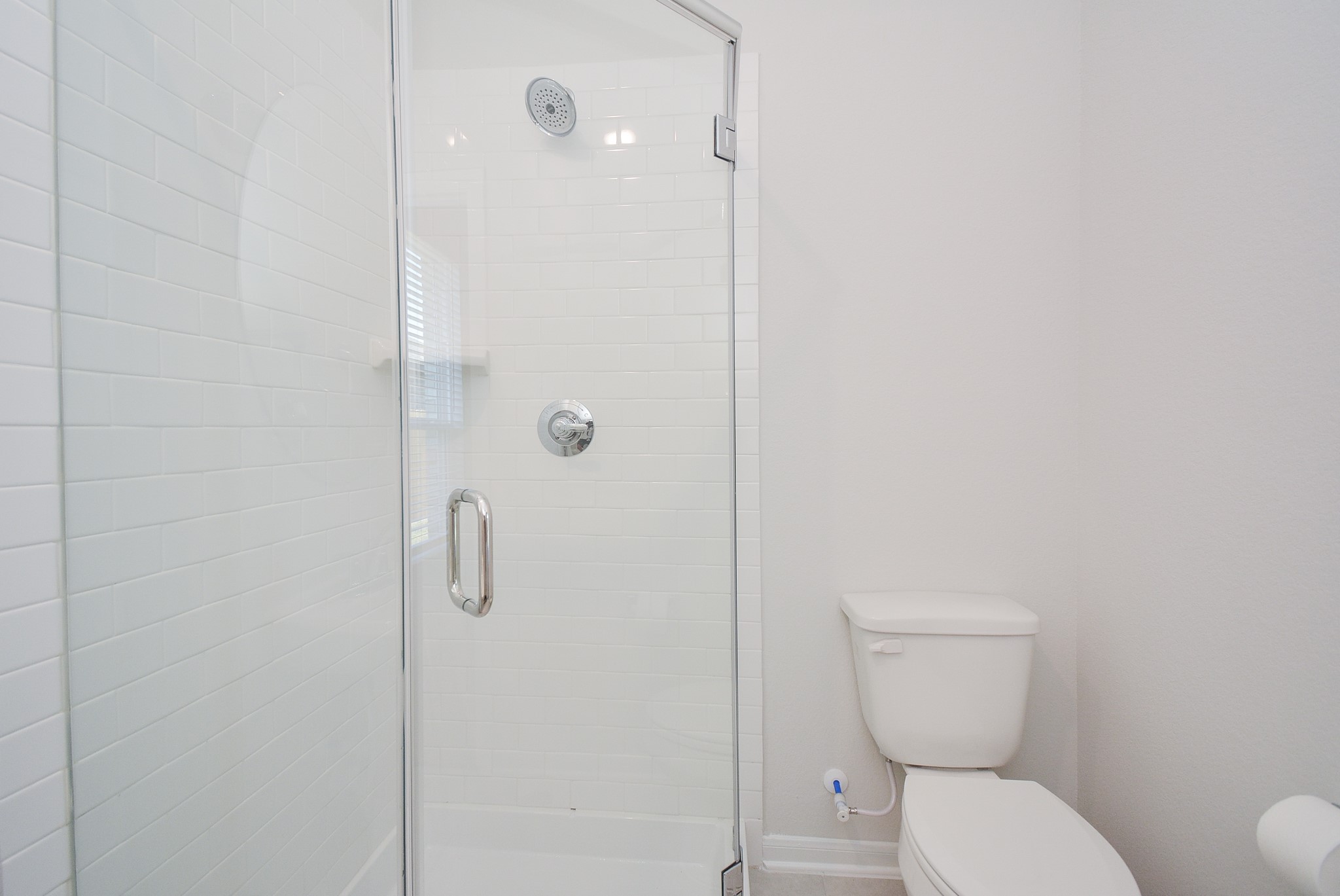 8634 Herring Lane Cypress, TX 77433 - Photo 40 of 50 a white toilet sitting next to a bathroom sink