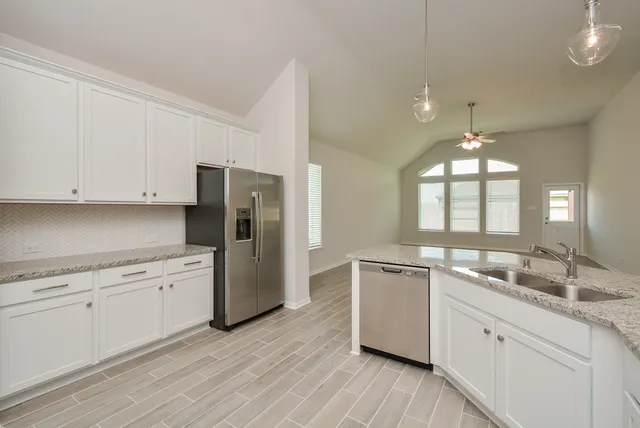 a kitchen with a sink stove and refrigerator