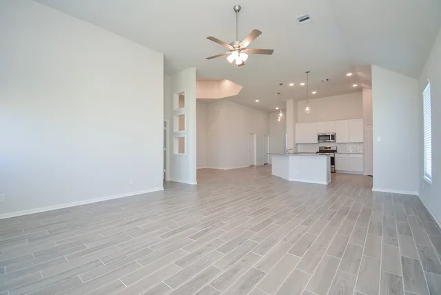 a view of kitchen with livingroom view and wooden floor
