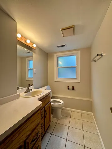 a bathroom with a sink a toilet and mirror