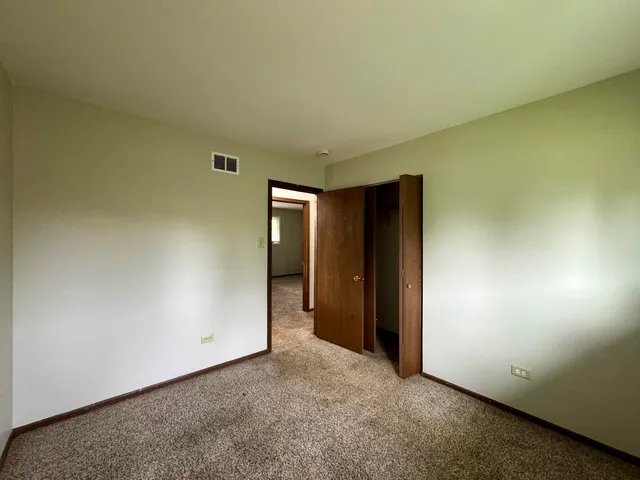 an empty room with closet area