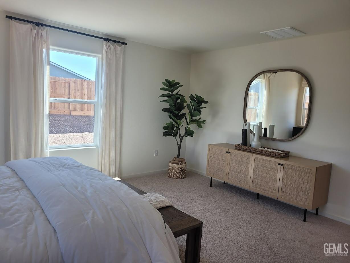 Undisclosed Address Bakersfield, CA 93307 - Photo 21 of 23 a bedroom with bed and a potted plant