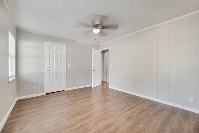 a view of an empty room with wooden floor