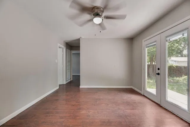 wooden floor in an empty room with a window