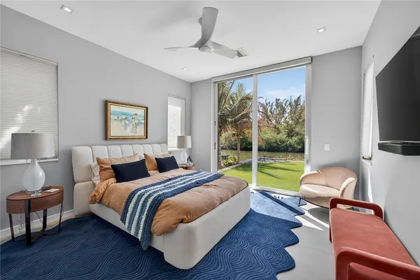 a living room with patio furniture and a large window