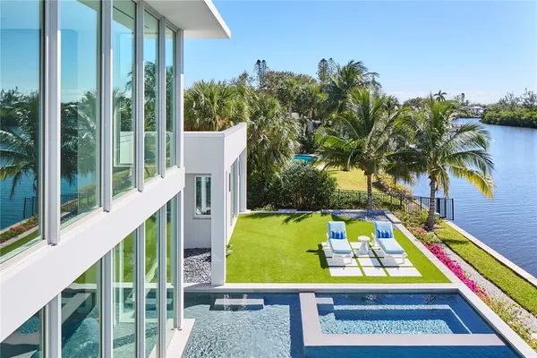 a view of a lake with couches chairs