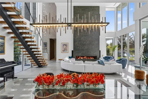 a living room with furniture and large windows