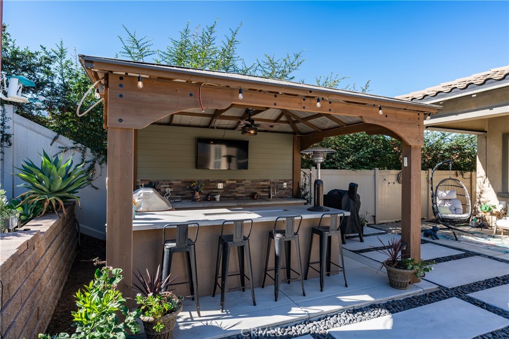 11137 Briar Rose Court Corona, CA 92883 - Photo 59 of 75 a view of a patio with table and chairs potted plants and floor to ceiling window