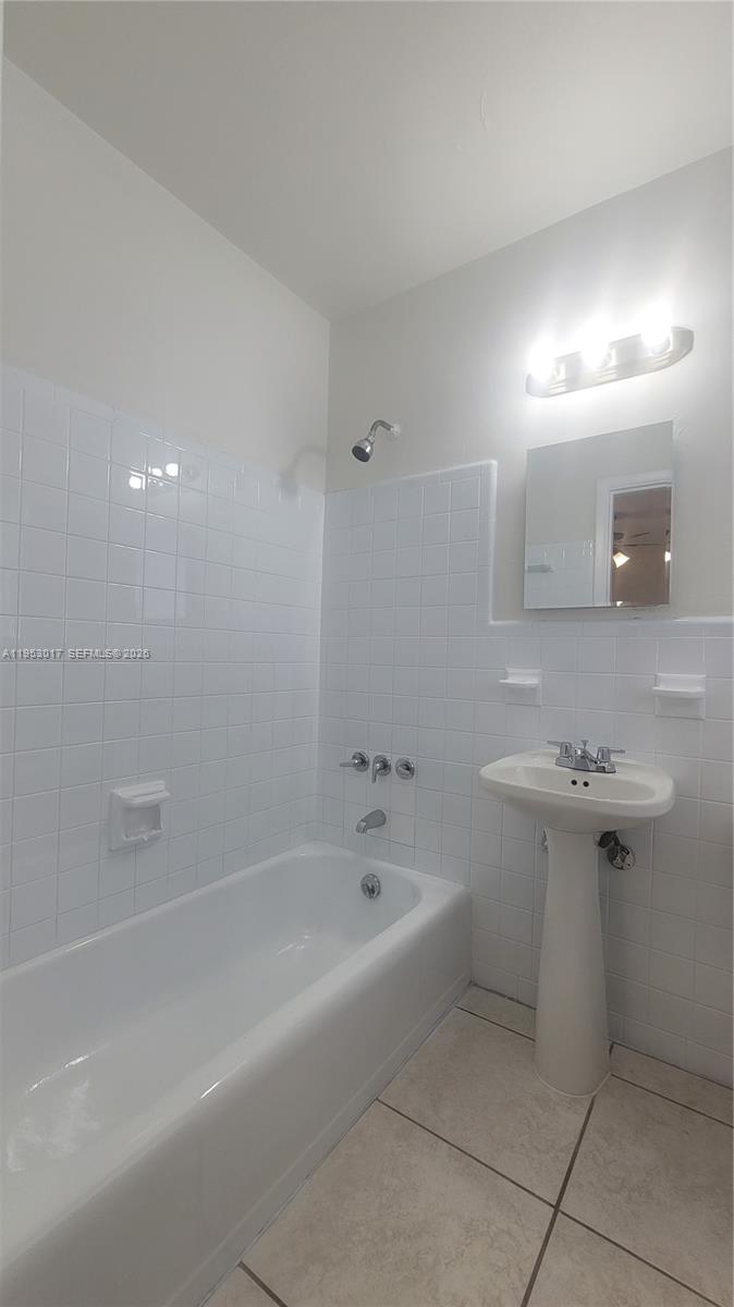 2601 Southwest 22nd Avenue, Unit 11 Miami, FL 33133 - Photo 8 of 10 a spacious bathroom with a bathtub and a sink