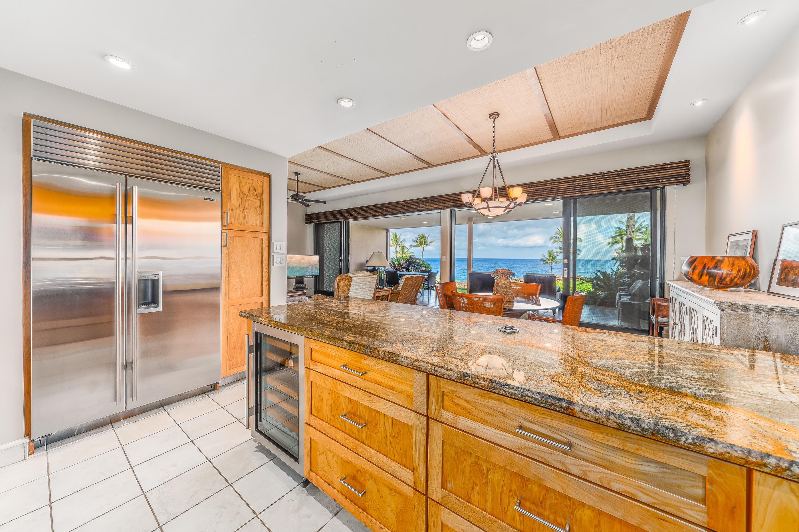 4850 Makena Alanui Road, Unit C106 Kihei, HI 96753 - Photo 13 of 49 a kitchen with stainless steel appliances granite countertop a sink and a refrigerator