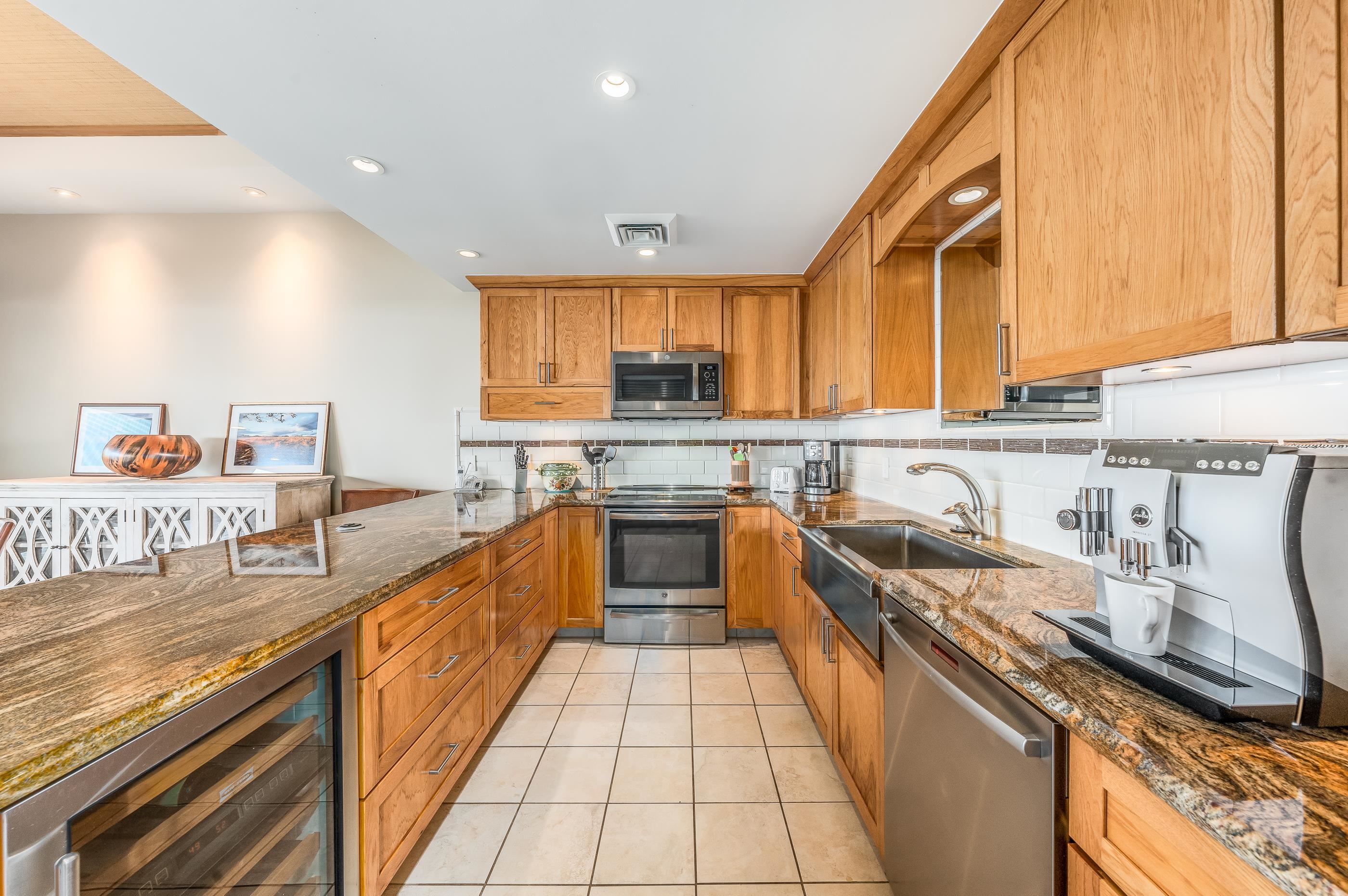 4850 Makena Alanui Road, Unit C106 Kihei, HI 96753 - Photo 14 of 49 a kitchen with stainless steel appliances granite countertop a sink and a stove