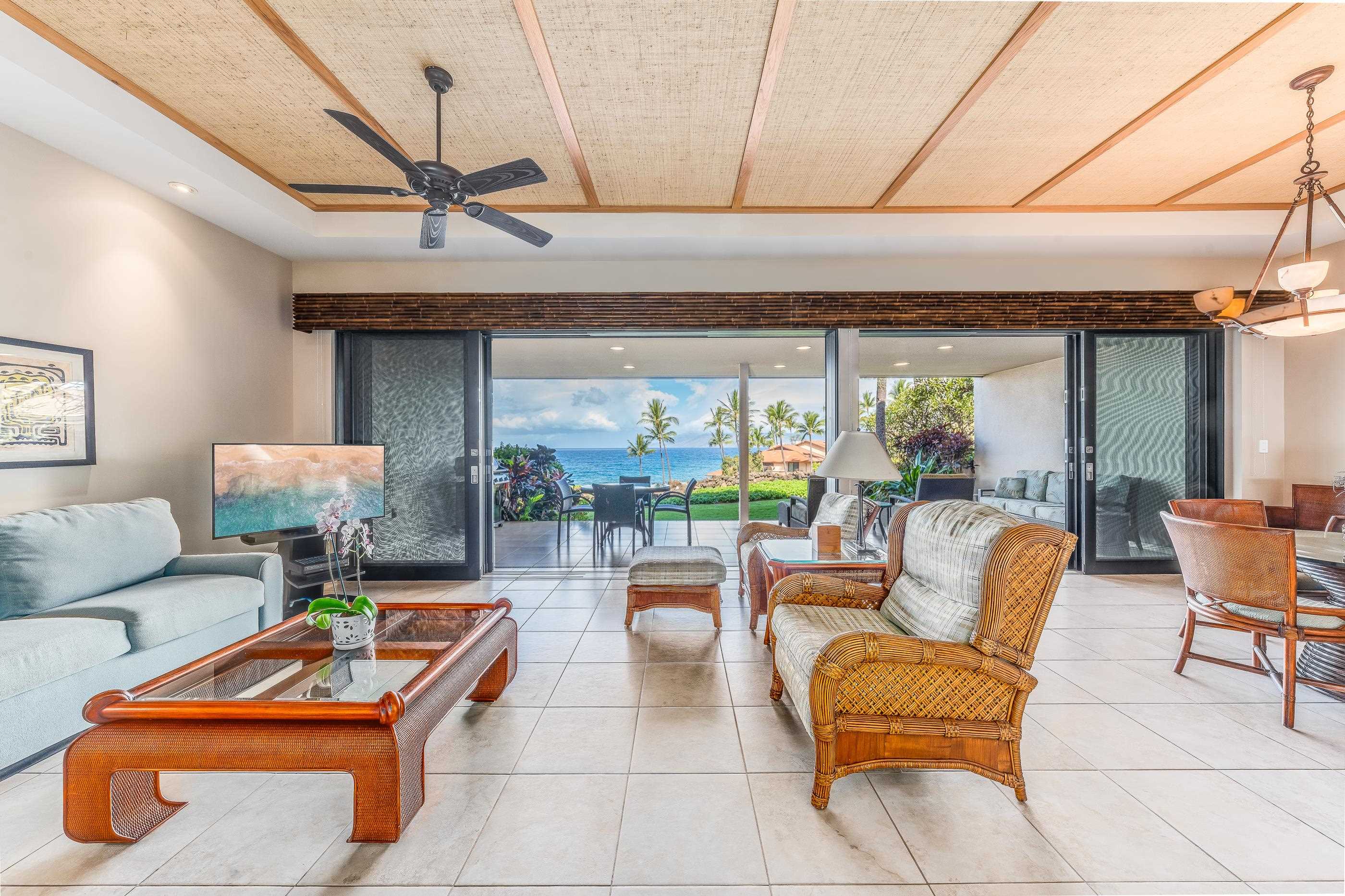 4850 Makena Alanui Road, Unit C106 Kihei, HI 96753 - Photo 16 of 49 a living room with furniture a flat screen tv and a table