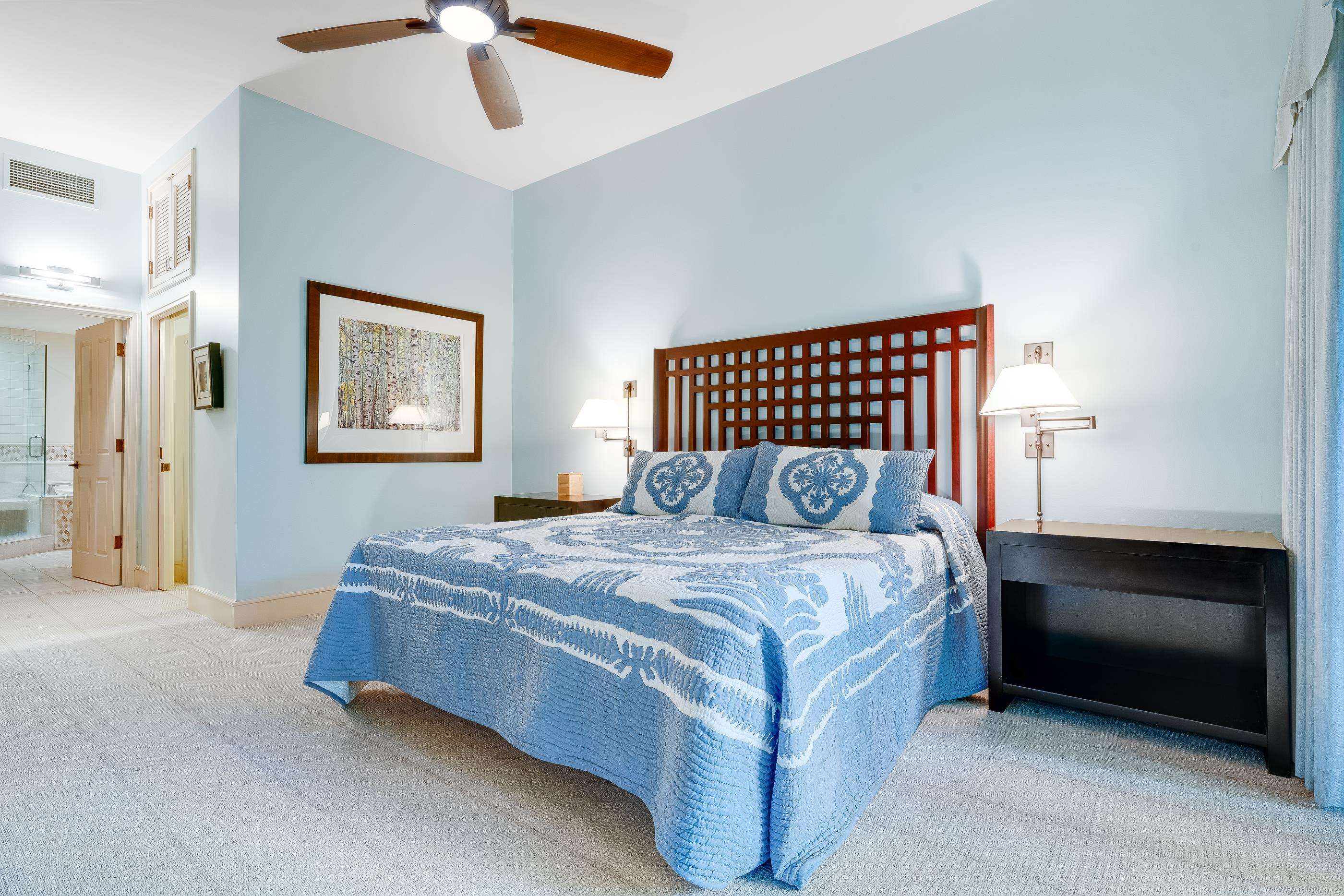 4850 Makena Alanui Road, Unit C106 Kihei, HI 96753 - Photo 20 of 49 a bedroom with a bed and painting on the wall