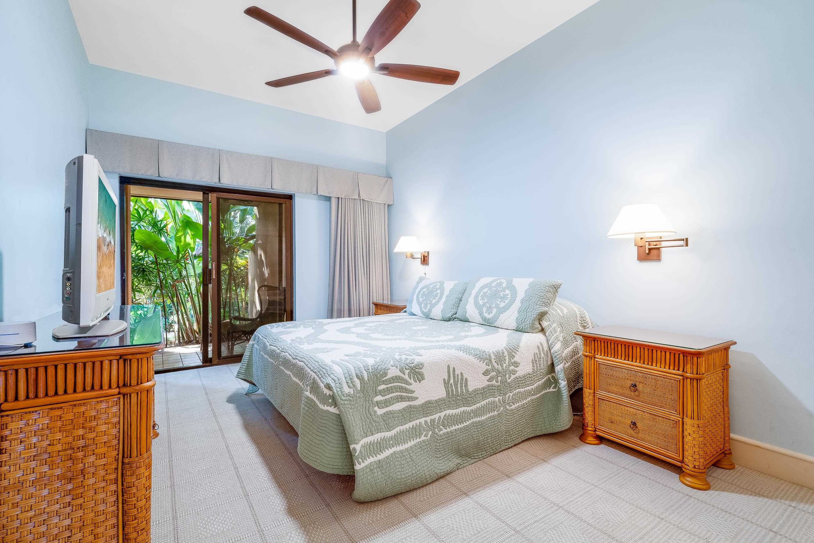 4850 Makena Alanui Road, Unit C106 Kihei, HI 96753 - Photo 25 of 49 a bedroom with a bed and a large window