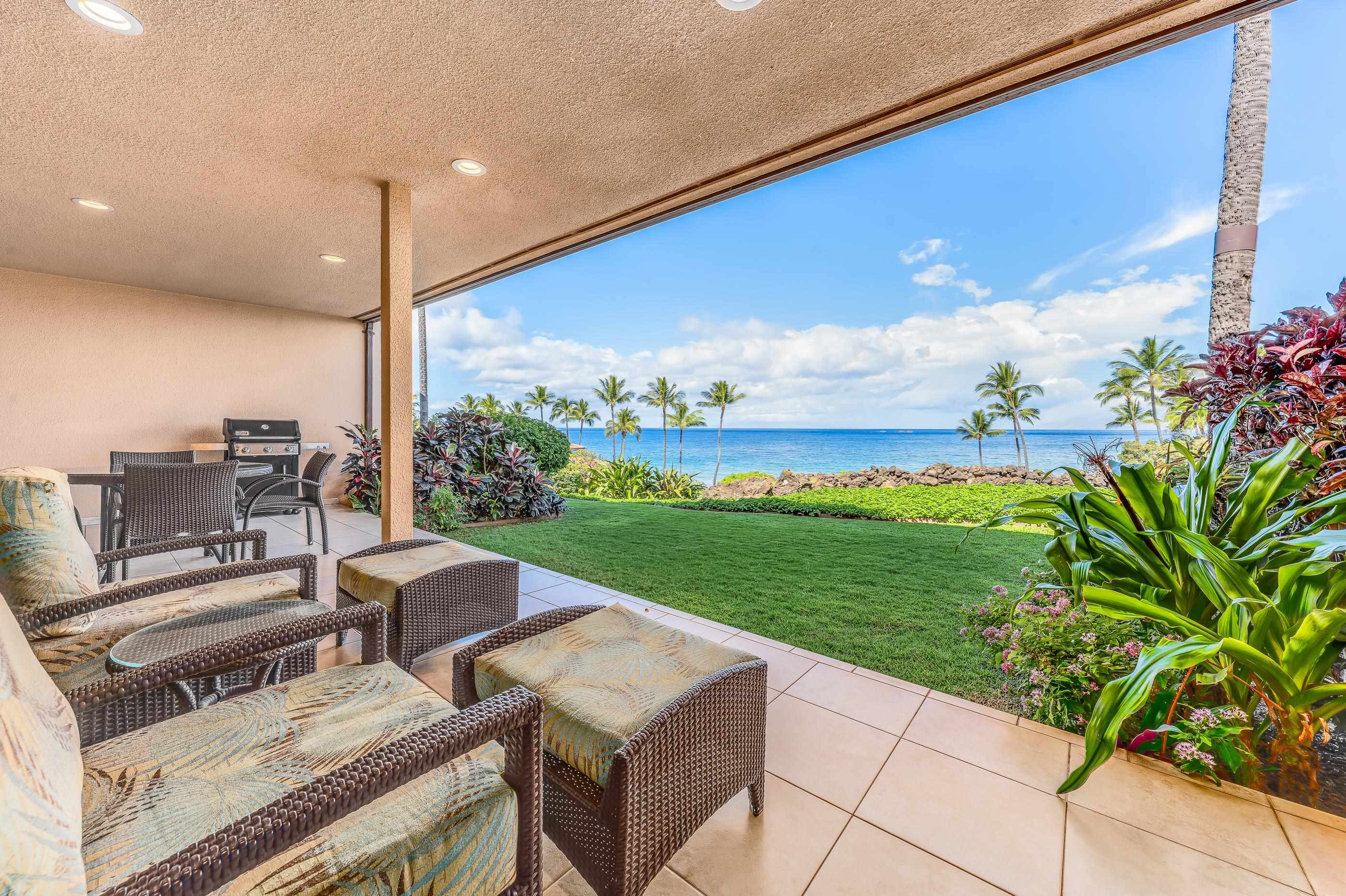 4850 Makena Alanui Road, Unit C106 Kihei, HI 96753 - Photo 3 of 49 a roof deck with table and chairs and potted plants