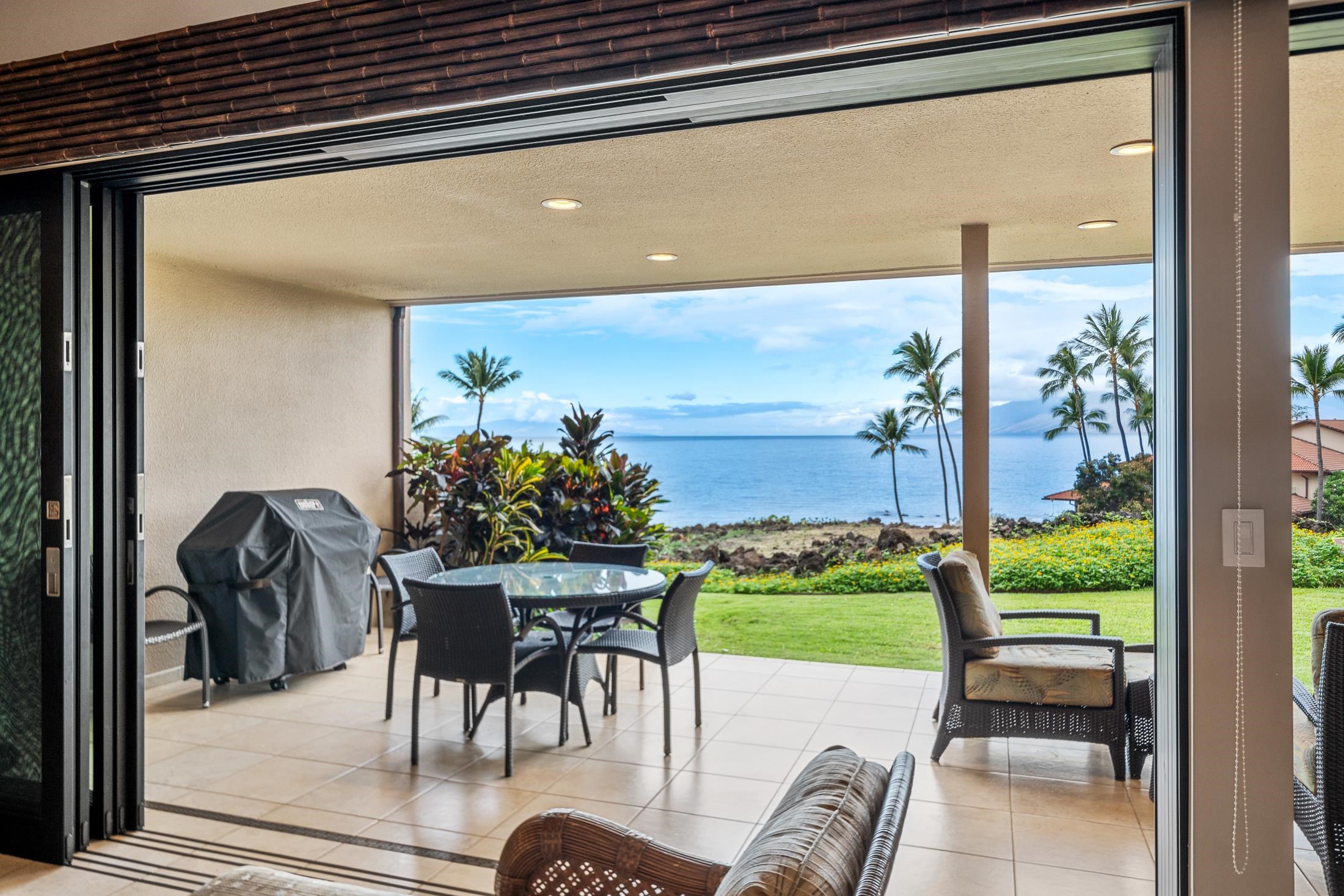 4850 Makena Alanui Road, Unit C106 Kihei, HI 96753 - Photo 32 of 49 a patio with table and chairs