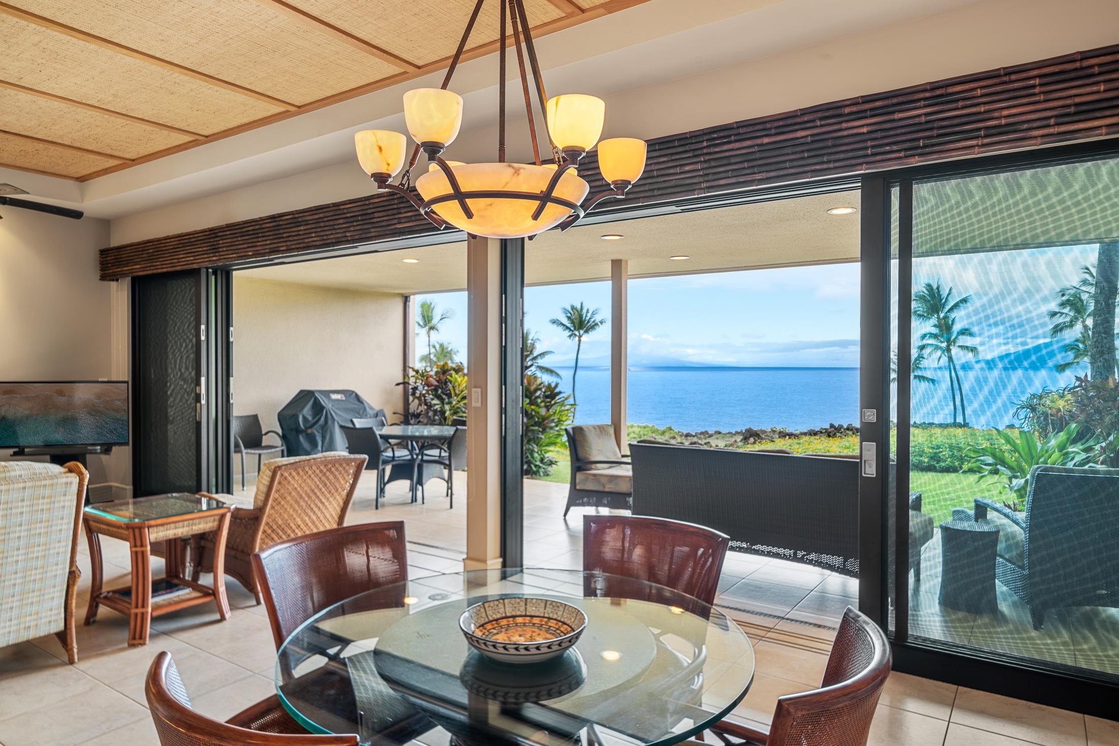 4850 Makena Alanui Road, Unit C106 Kihei, HI 96753 - Photo 33 of 49 a dining room with furniture a chandelier and window