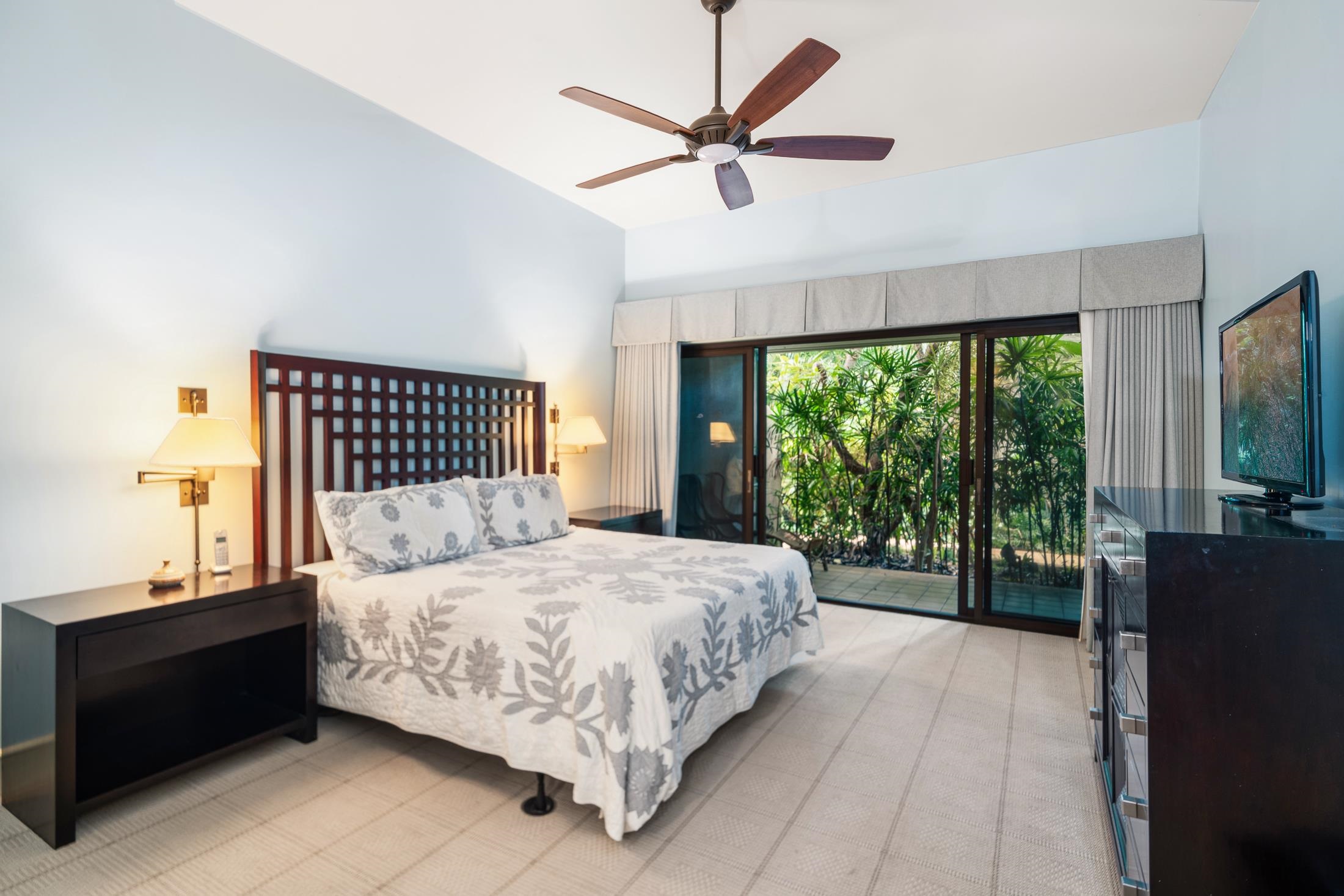 4850 Makena Alanui Road, Unit C106 Kihei, HI 96753 - Photo 34 of 49 a bedroom with a large bed and a large window