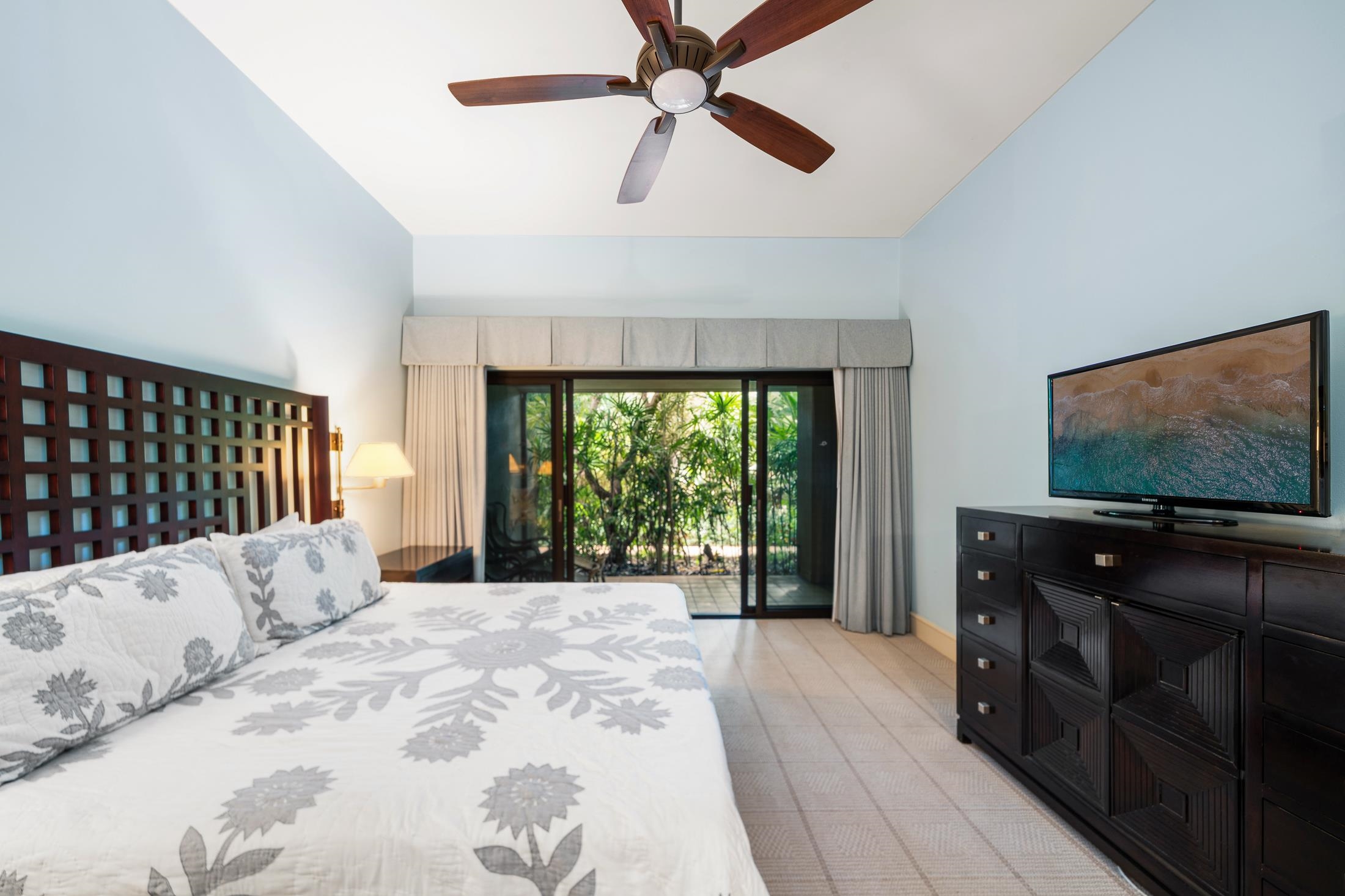 4850 Makena Alanui Road, Unit C106 Kihei, HI 96753 - Photo 35 of 49 a bedroom with a bed and a flat screen tv