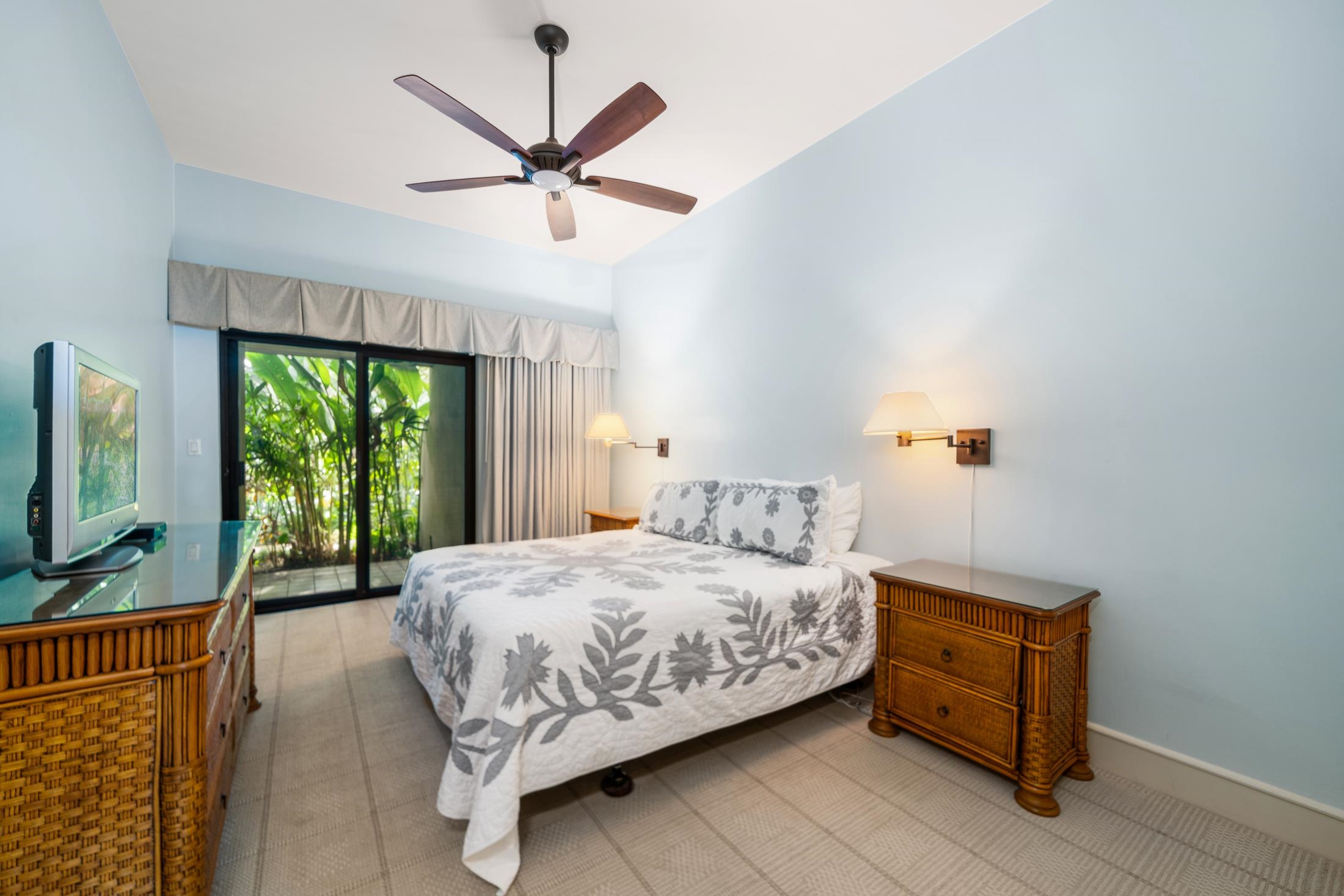 4850 Makena Alanui Road, Unit C106 Kihei, HI 96753 - Photo 36 of 49 a bedroom with a bed a window and a flat screen tv