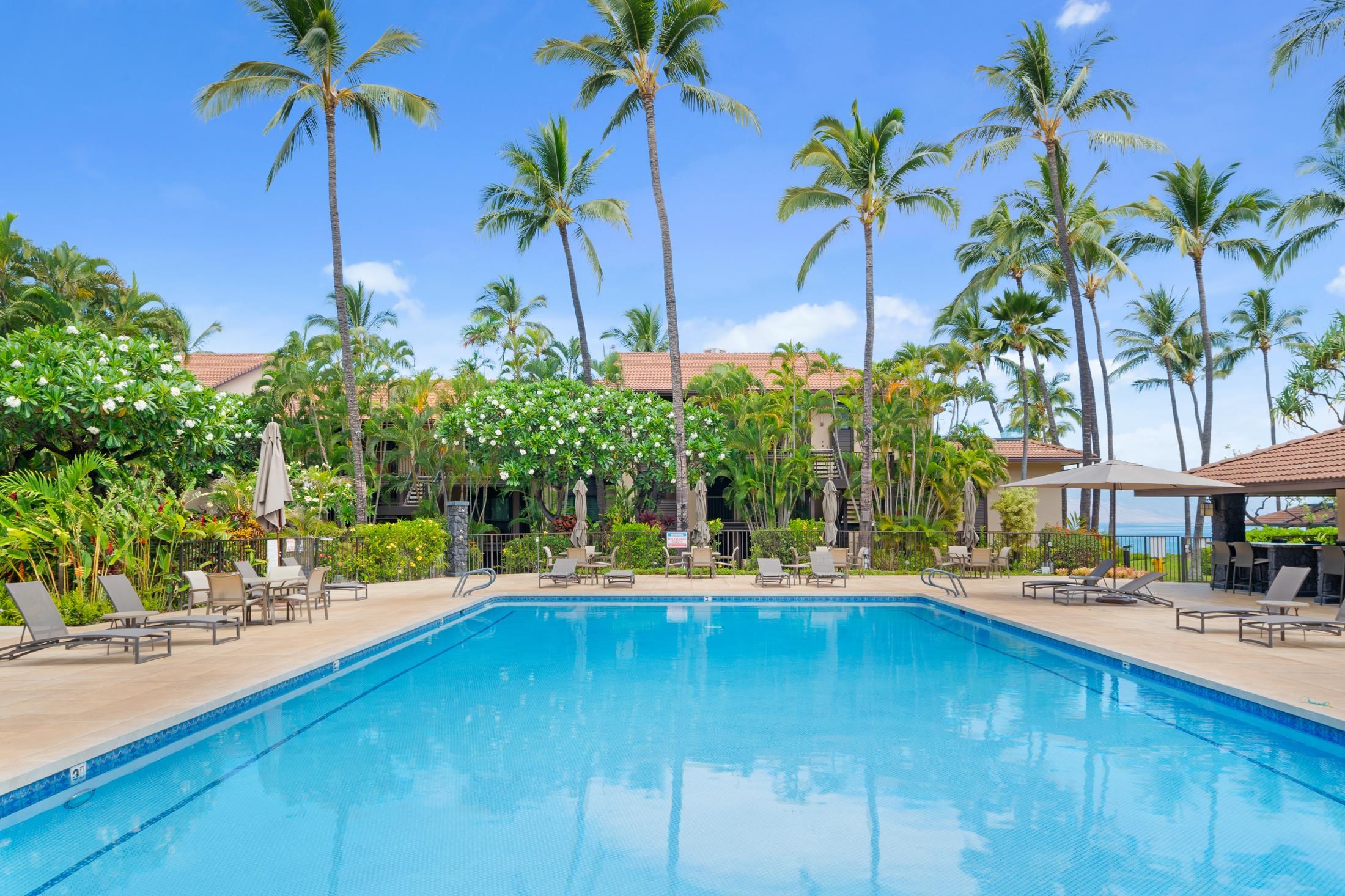 4850 Makena Alanui Road, Unit C106 Kihei, HI 96753 - Photo 40 of 49 a swimming pool with outdoor seating and yard