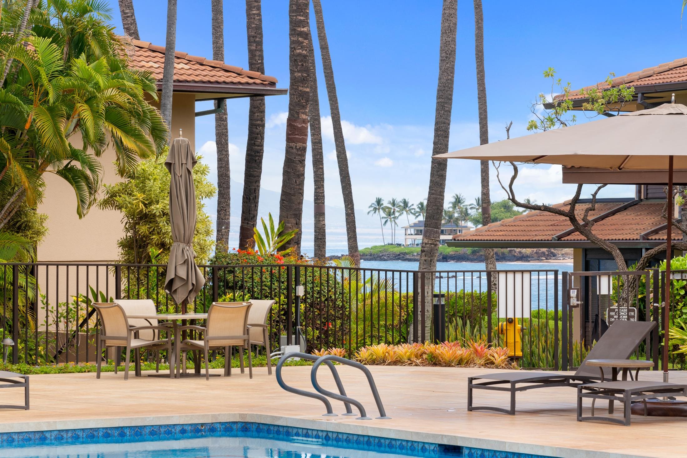 4850 Makena Alanui Road, Unit C106 Kihei, HI 96753 - Photo 42 of 49 a view of a patio with a table and chairs