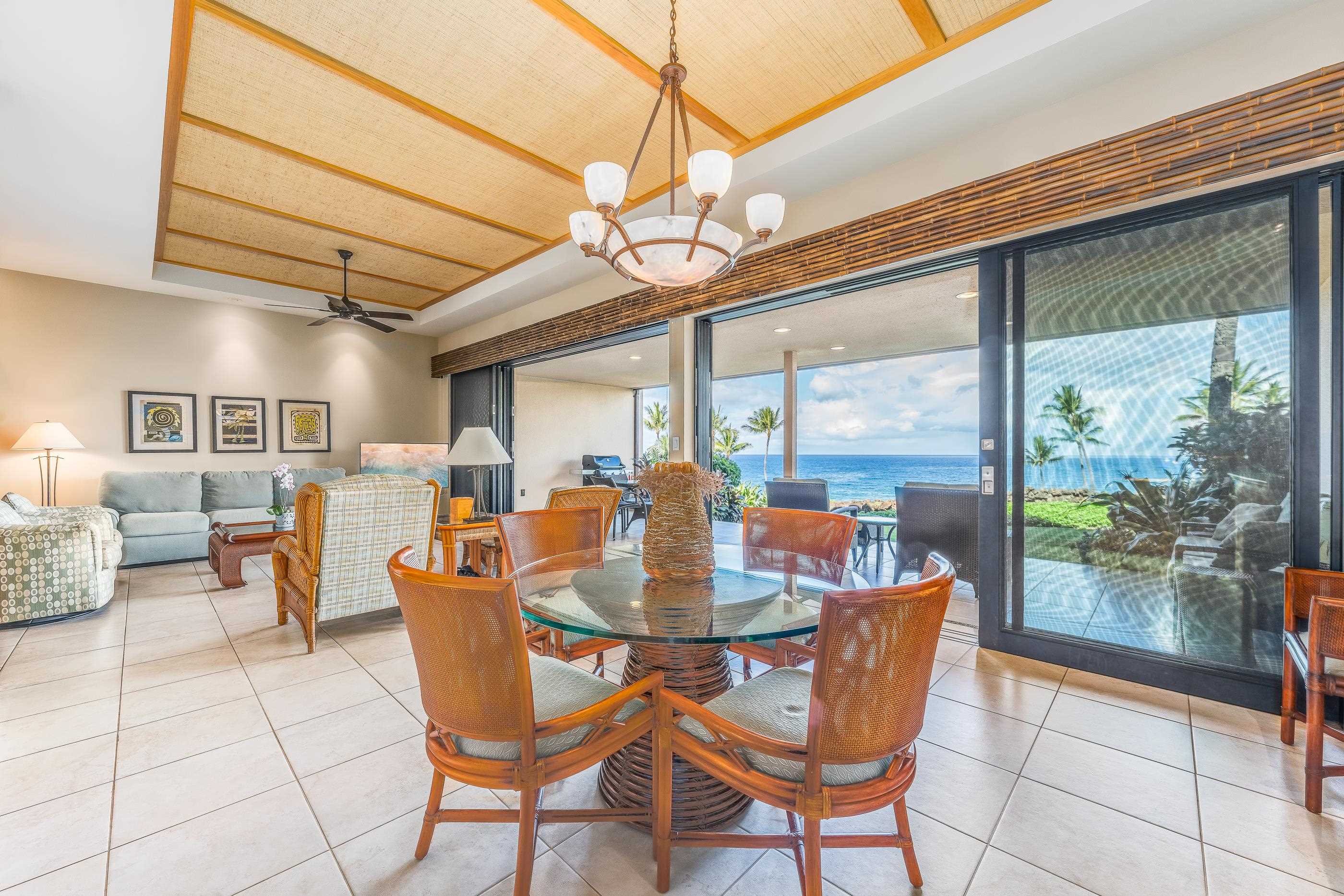 4850 Makena Alanui Road, Unit C106 Kihei, HI 96753 - Photo 10 of 49 a dining room with furniture a chandelier and wooden floor