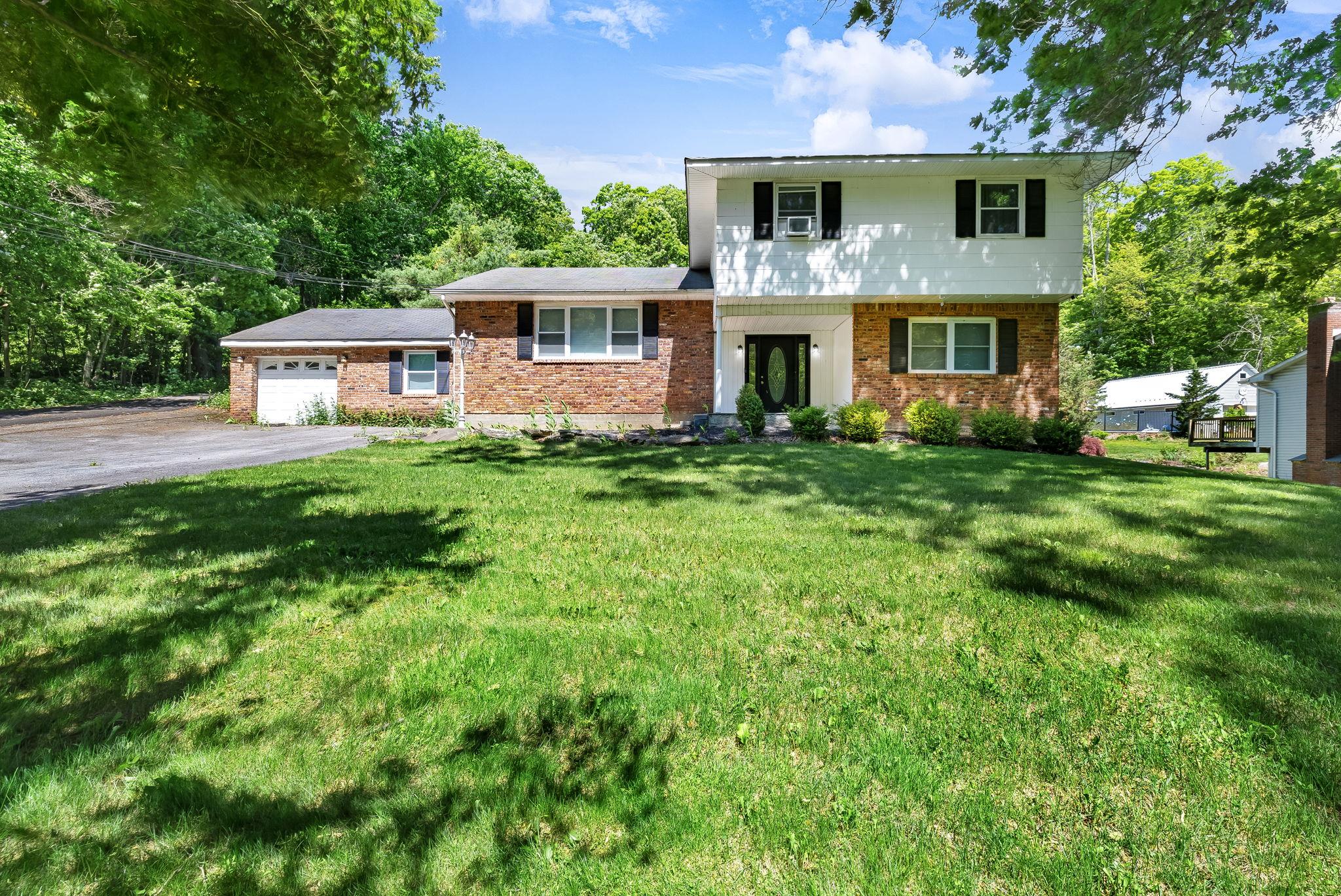 a front view of a house with a yard