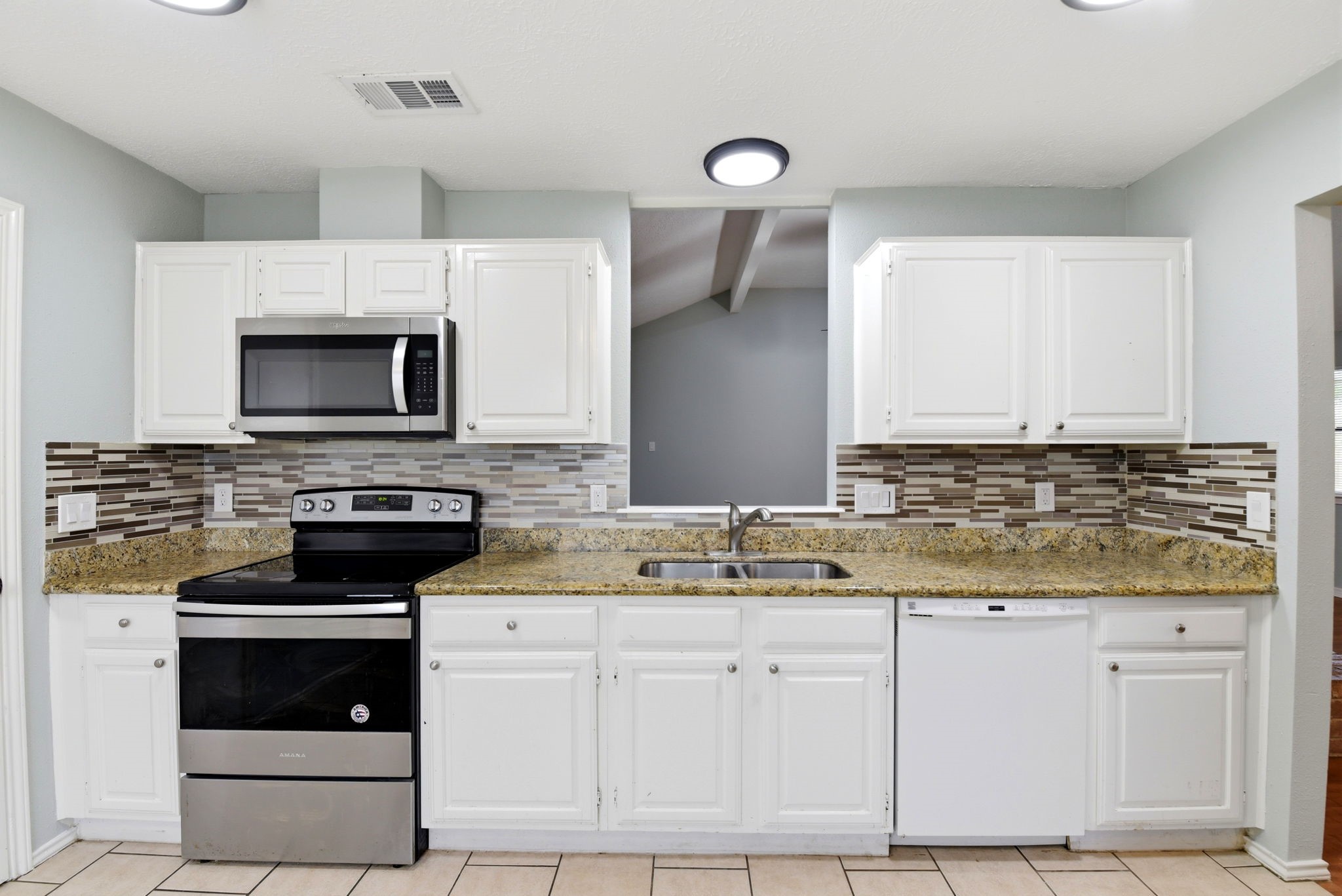 21330 Golden Dove Drive Spring, TX 77388 - Photo 11 of 29 A close-up of your cooking zone highlights the sleek range and the gorgeous mosaic tile backsplash that ties the whole room together.