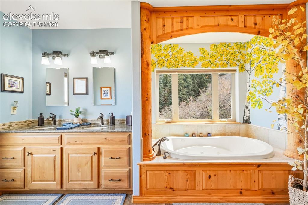 858 Oak Ridge Road Manitou Springs, CO 80829 - Photo 29 of 50 5 piece en suite bathroom with custom mural, dual sinks, a walk in shower and jetted soaking tub