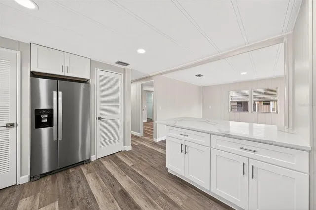a bathroom with a sink vanity and a mirror