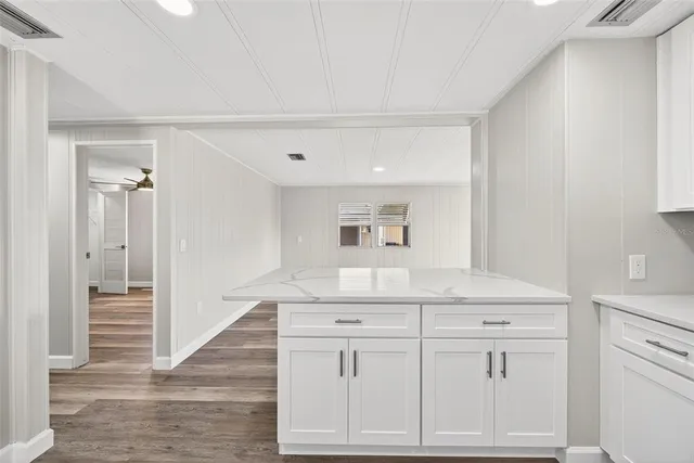 a kitchen with stainless steel appliances granite countertop a refrigerator a sink and a stove