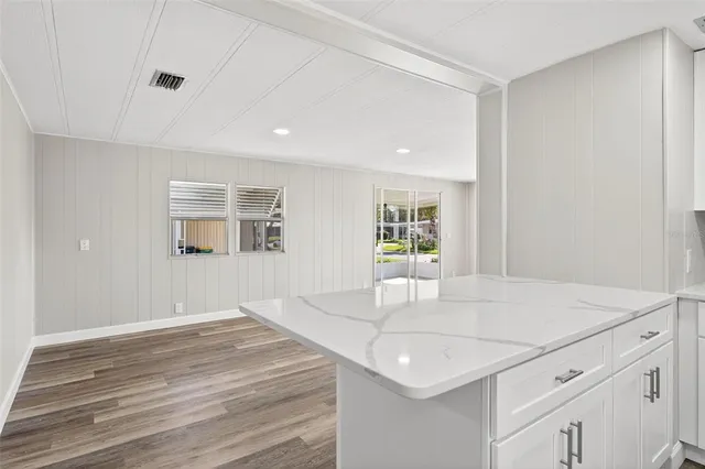 a view of kitchen with granite countertop stainless steel appliances refrigerator sink and cabinets
