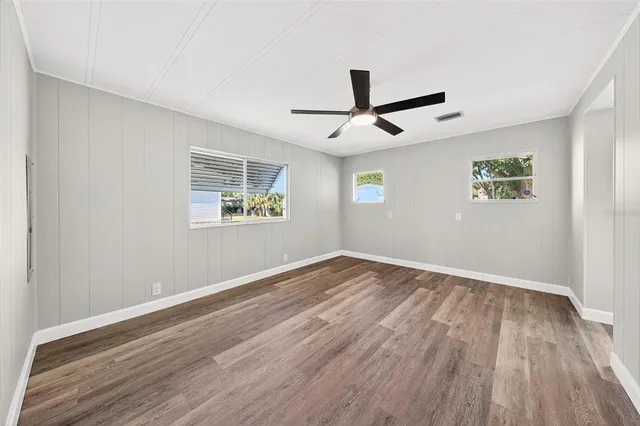 wooden floor in an empty room with a window