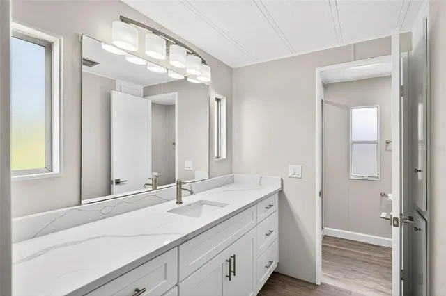 a bathroom with a sink a mirror and a bathtub