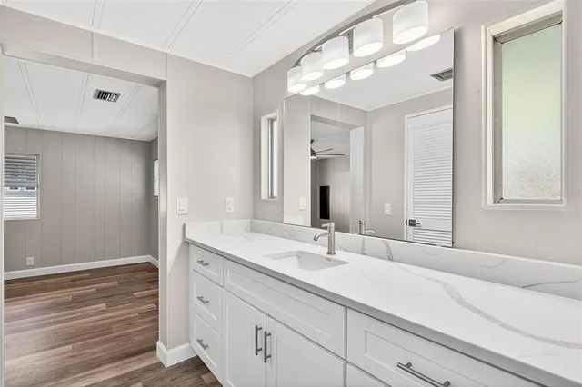 a view of an empty room with closet and wooden floor
