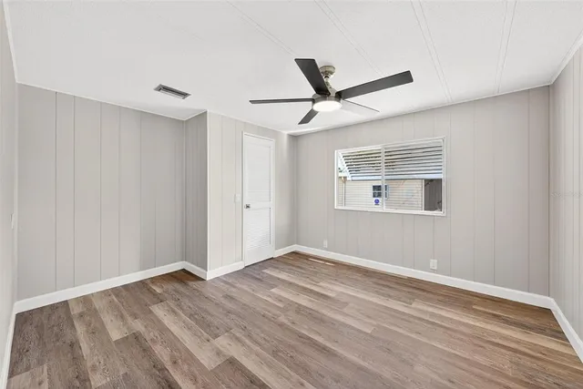 wooden floor in an empty room with a window