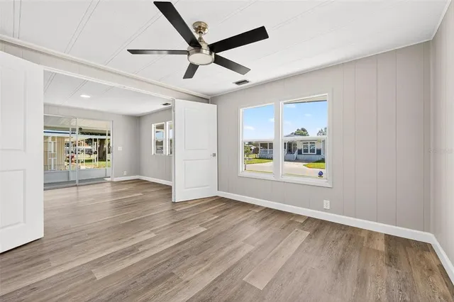 a view of an empty room with window and cabinet