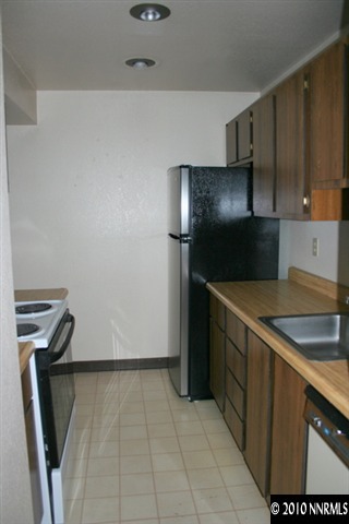 4394 Matich Drive Reno, NV 89502 - Photo 4 of 8 a kitchen with a refrigerator and a stove