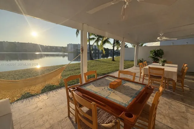 a kitchen with granite countertop white cabinets and sink
