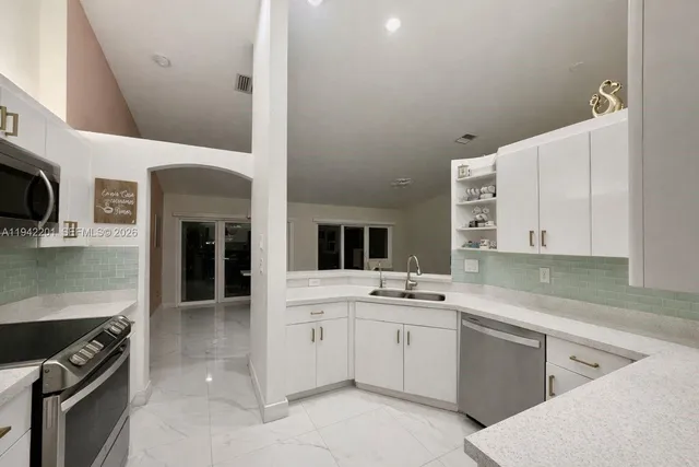 a front view of a house with garden and trees