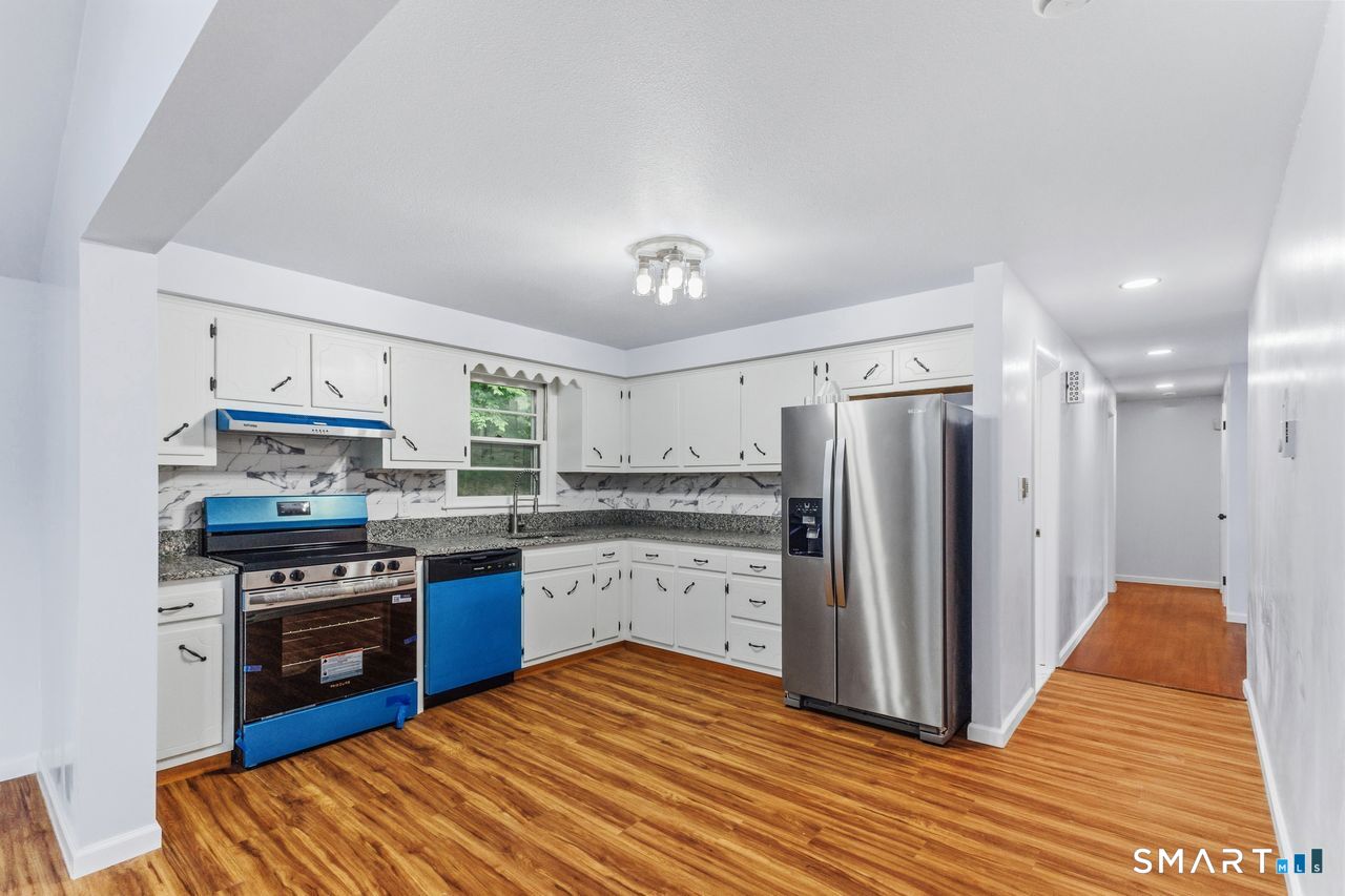 17 Rhoda Lane Bristol, CT 06010 - Photo 7 of 22 a kitchen with stainless steel appliances granite countertop a stove refrigerator and a sink