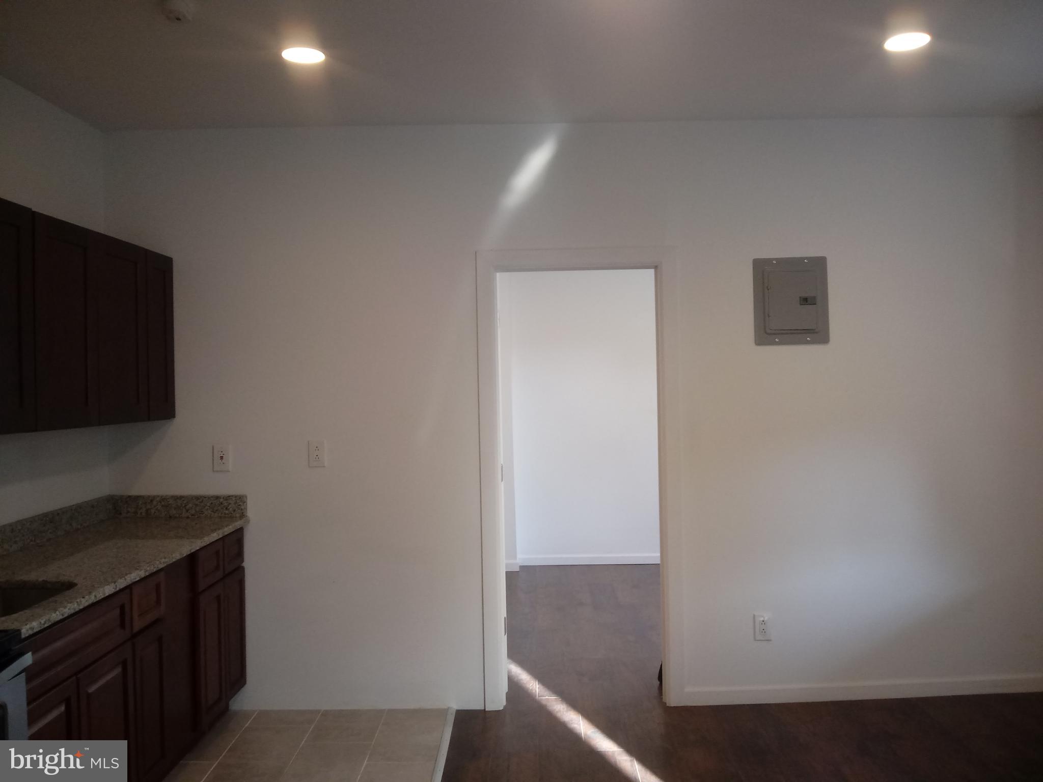 1145 South 23rd Street, Unit 1 Philadelphia, PA 19146 - Photo 2 of 12 a view of kitchen and wooden floor