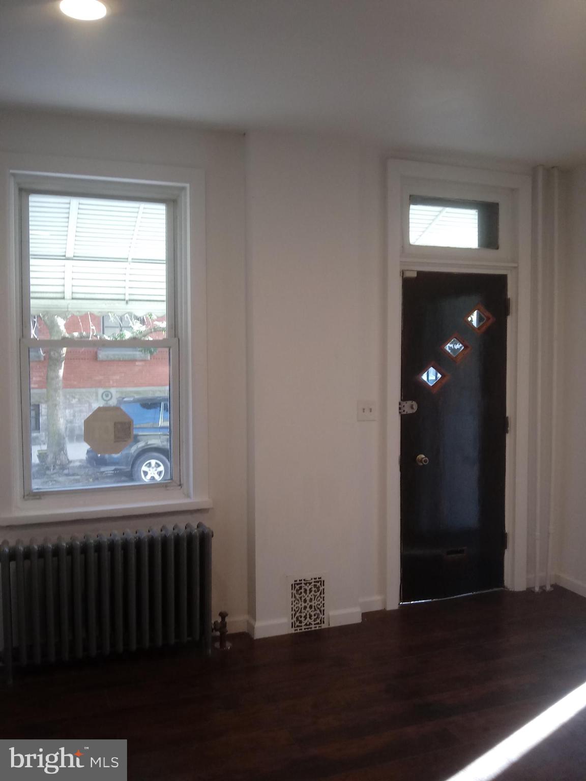 1145 South 23rd Street, Unit 1 Philadelphia, PA 19146 - Photo 3 of 12 a view of a hallway with wooden floor and a window