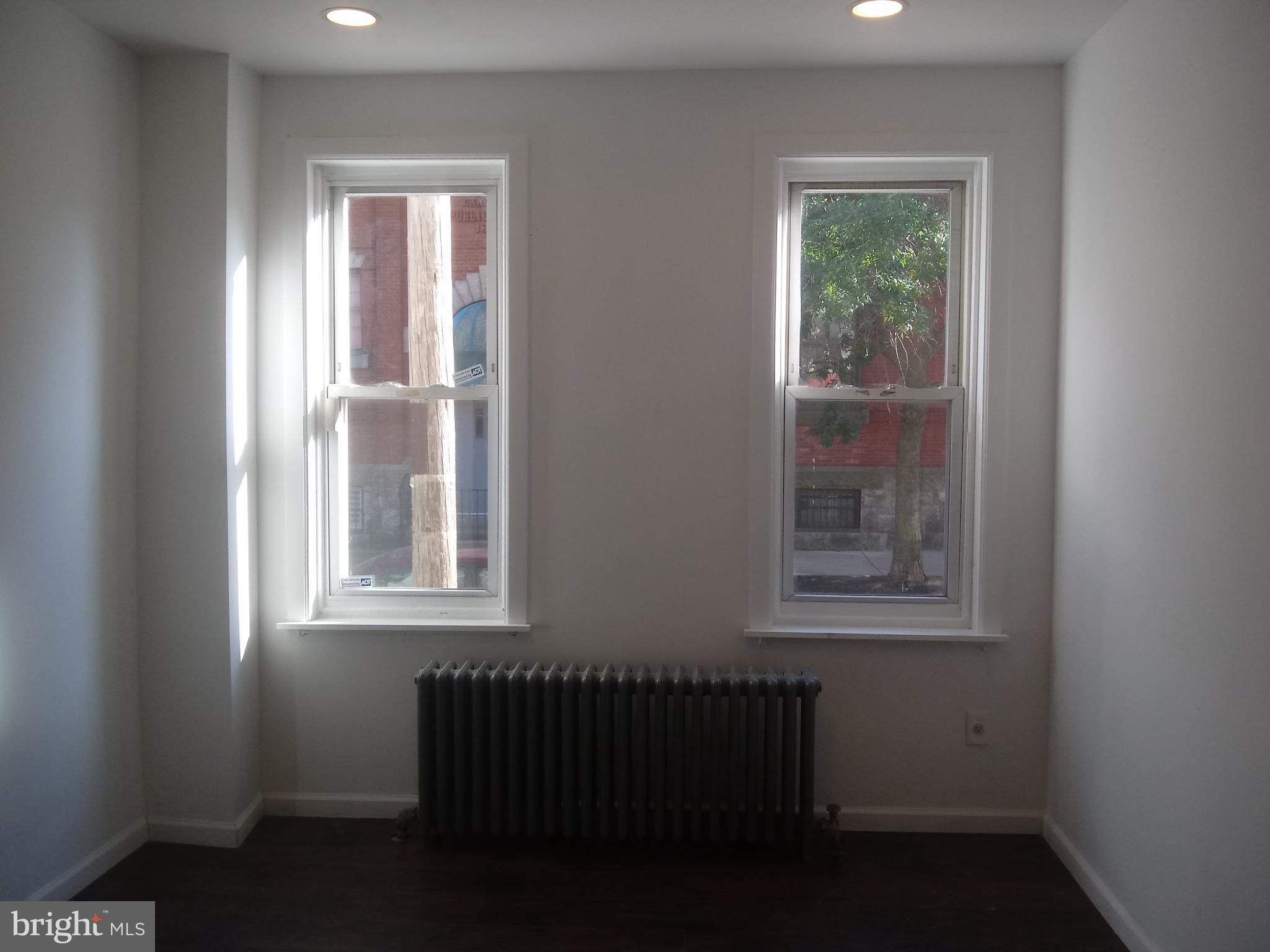 1145 South 23rd Street, Unit 1 Philadelphia, PA 19146 - Photo 4 of 12 an empty room with windows