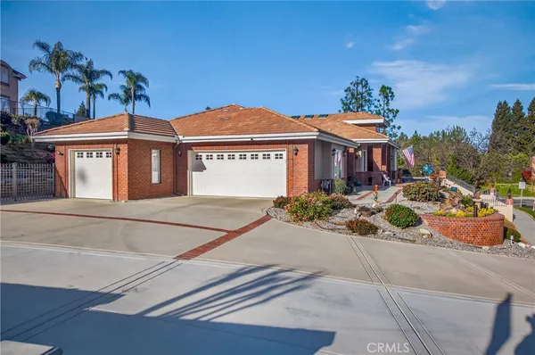 a aerial view of a house with a yard and potted plants